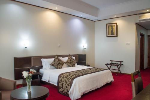 a hotel room with a bed and a table at Lake View Resort Hotel in Mbarara