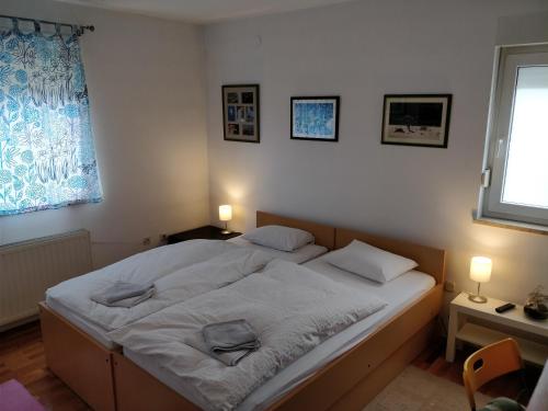 a bed in a bedroom with two pillows on it at Savski Gaj in Zagreb
