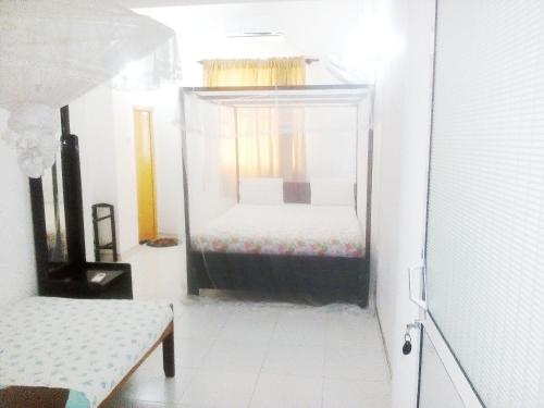 a bedroom with a bed in a glass room at Mirissa Harbour View in Mirissa