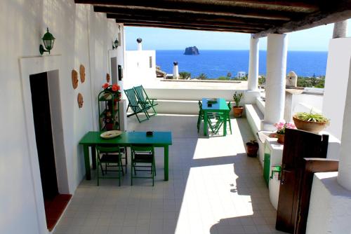 a room with a table and chairs and a balcony at Case Vacanza Gia.no in Stromboli