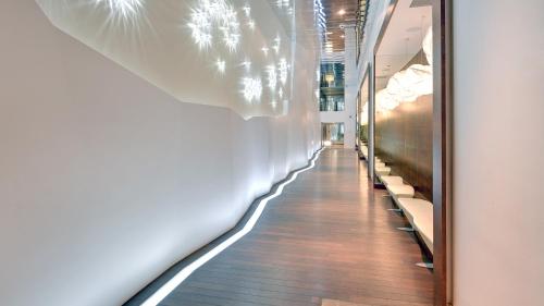 a hallway in a building with a mirror on the wall at Dom & House - Apartamenty Sea Towers in Gdynia