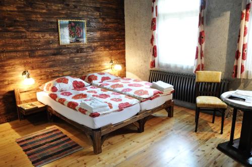 a bedroom with a bed and a wooden wall at Penzión Tokaj Ostrožovič in Veľká Tŕňa