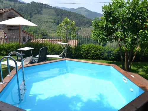 a swimming pool in the backyard of a house at Capannori Stylish Townhouse in Castelvecchio