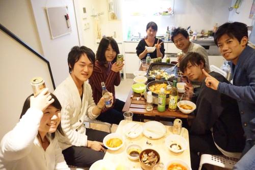 a group of people sitting around a table eating food at Tokyo Art House in Tokyo