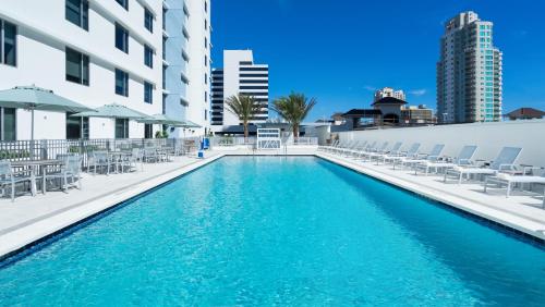a swimming pool with chairs and a building at Hyatt Place St. Petersburg/Downtown in St. Petersburg