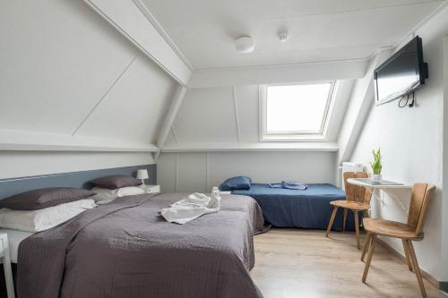 A bed or beds in a room at Apart Hotel Het Veerse Meer