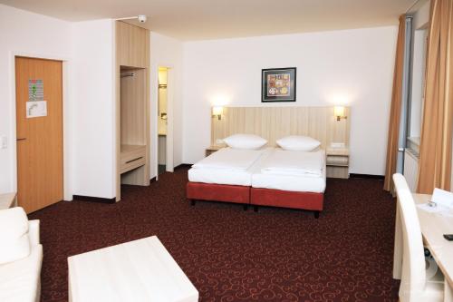 Postel nebo postele na pokoji v ubytování Hotel Quickborn & Gästehaus Hesse
