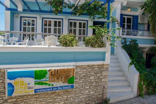 a building with a sign that reads restoration on the beach at Hotel Mariona in Pythagoreio