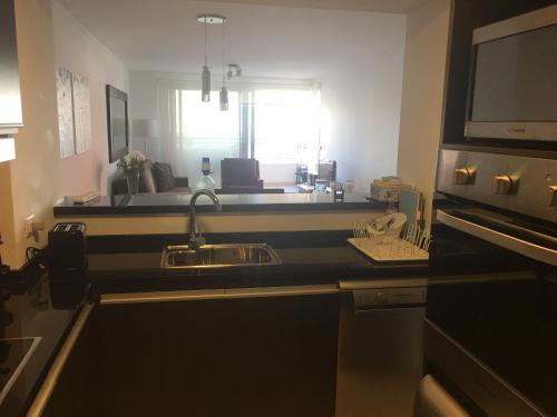 a kitchen with a sink and a counter top at Apartamento Forest 2 in Punta del Este