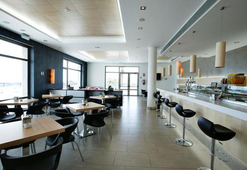 a dining room with tables and chairs in a restaurant at 01 Loft Alenda Golf in Monforte del Cid