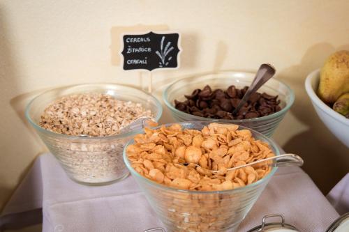 three bowls of nuts and raisins on a table at Boutique Hotel San Rocco in Brtonigla