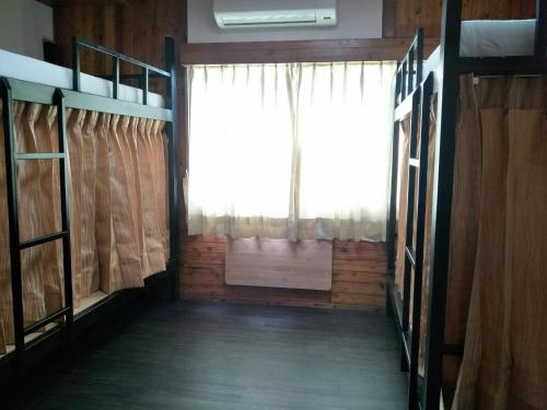 a room with a window and bunk beds in it at Yes, Sir Homestay in Nangan