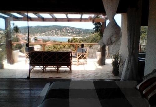a view of a patio with a table and chairs at Villa Ferradura in Búzios