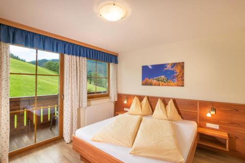 1 dormitorio con cama y ventana grande en Hinteregghof, en Forstau