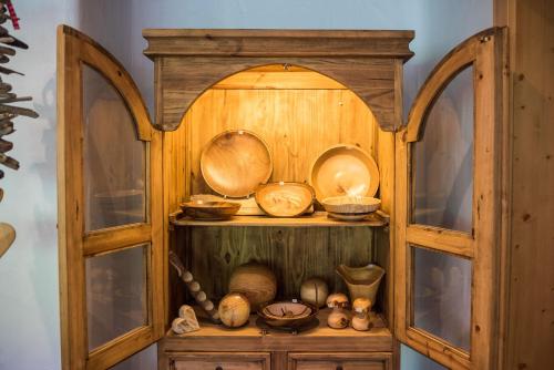 a wooden cabinet filled with bowls and pans at Hinteregghof in Forstau