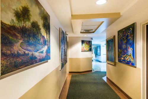 a hallway with paintings on the walls at GH Galeria Hotel in Guayaquil