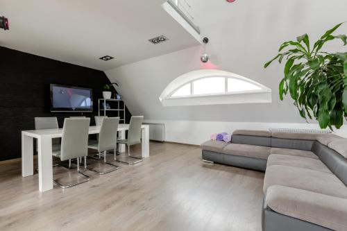 a living room with a couch and a table at Penthouse Apartment with Terrace in Rīga