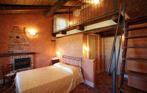 a bedroom with a bunk bed and a fireplace at Cà San Ponzio country house & SPA in Barolo