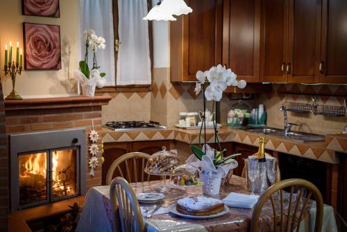a kitchen with a dining table with a fireplace at La Finestra Sui Cento Portali in Pignola