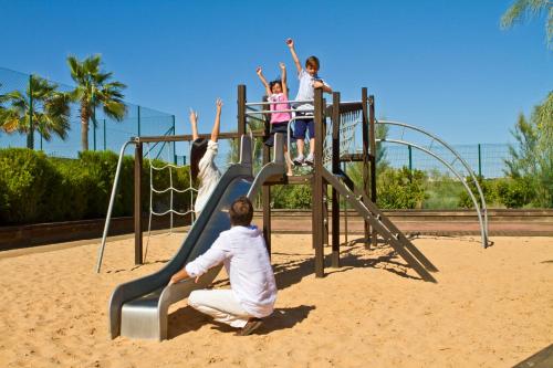 a group of children on a slide at a playground at Eurotel Altura in Altura