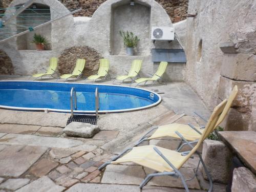 a group of chairs next to a swimming pool at U Zámku in Stráž nad Nežárkou