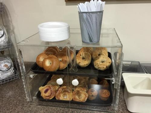 a display case filled with different types of donuts at Cadillac Inn in Cadillac