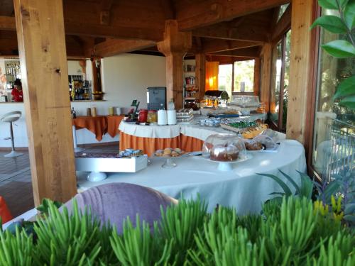 a table with food on it in a room at Hotel Residence Piccolo in Parghelia