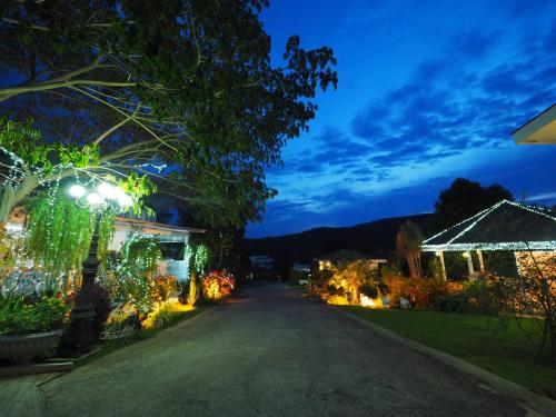 a house with lights on a driveway at night at Baan Ing Khao in Pak Chong