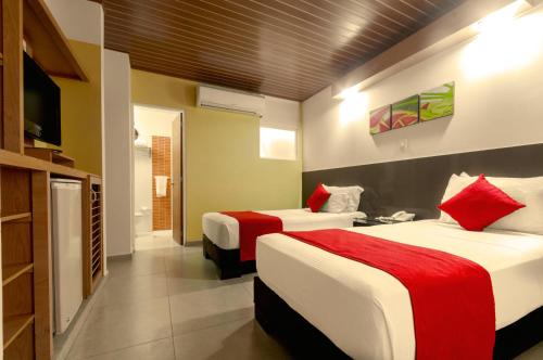 A bed or beds in a room at Waira Suites