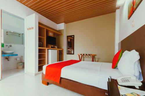 A bed or beds in a room at Waira Suites