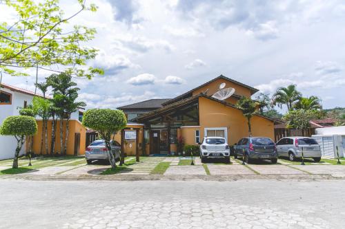 a house with cars parked in front of it at Pousada Rosa dos Ventos Juquehy in Juquei