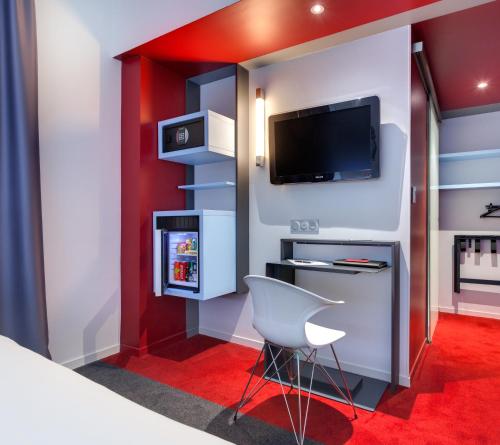 a room with a bed and a tv and a chair at ibis Styles Nantes Centre Gare in Nantes