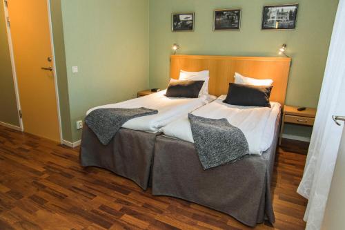 a bedroom with two beds with pillows on them at Hotell Frykenstrand; Sure Hotel Collection by Best Western in Sunne