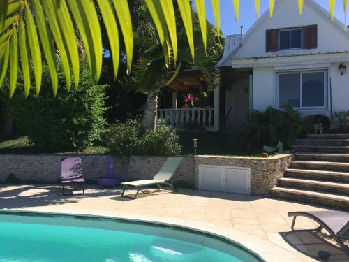 a house with a swimming pool in front of a house at villa MILA in Ravine Sèche