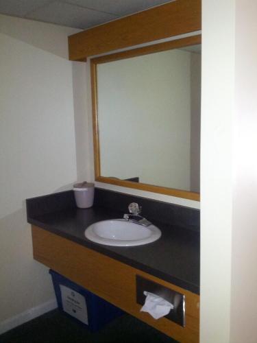 a bathroom with a sink and a mirror at Fairbanks Inn in Saint Johnsbury