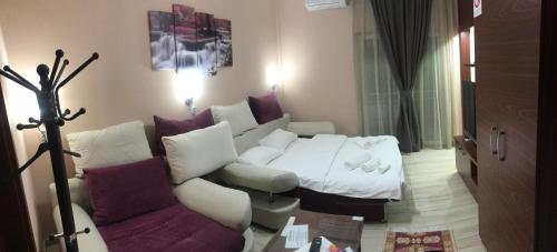 a living room with a couch and a bed at Prenociste DM5 in Novi Pazar