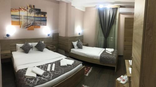 a hotel room with two beds in a room at Prenociste DM5 in Novi Pazar