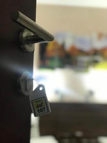 a lock on a door with a tag on it at Prenociste DM5 in Novi Pazar
