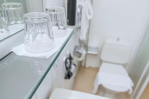 a bathroom with a toilet and a glass counter at Hotell Frykenstrand; Sure Hotel Collection by Best Western in Sunne