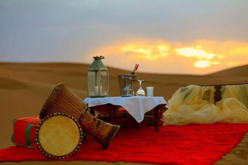 a table in the middle of the desert at Luxury Camp By DAR AZAWAD in Mhamid