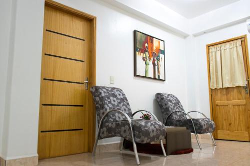 a room with two chairs and a door at Müller Hotel in Bella Vista