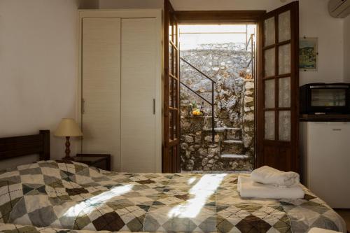 a bedroom with a bed and a window with a view at Villa Perris Studios in Kassiopi