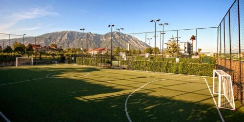 a tennis court with mountains in the background at My Place in Airola