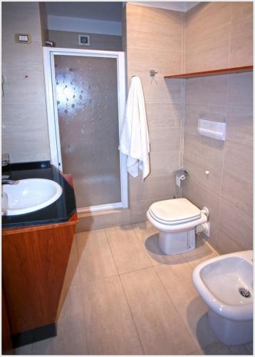 a bathroom with a sink and a toilet and a shower at My Place in Airola