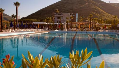 a large swimming pool with a mountain in the background at My Place in Airola