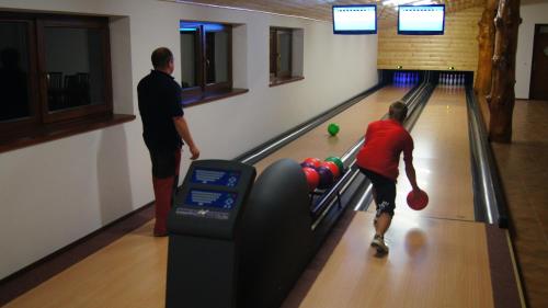 a couple of people playing a game of bowling at Penzion Pribisko in Zuberec