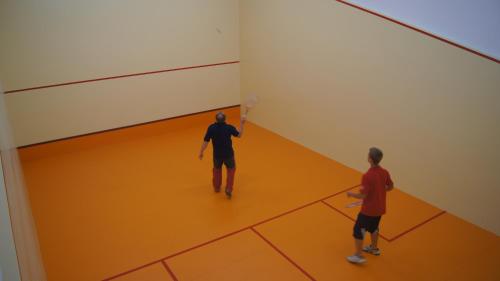 two men playing a game of basketball in a gym at Penzion Pribisko in Zuberec