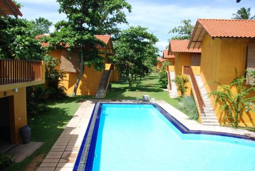 a swimming pool in the backyard of a house at Muthumuni Ayurveda Beach Resort in Beruwala