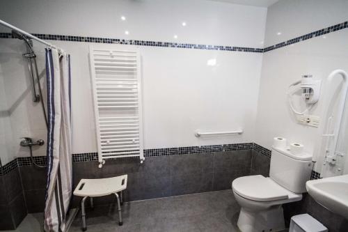 a bathroom with a toilet and a sink at Hotel Ria de Bilbao in Bilbao