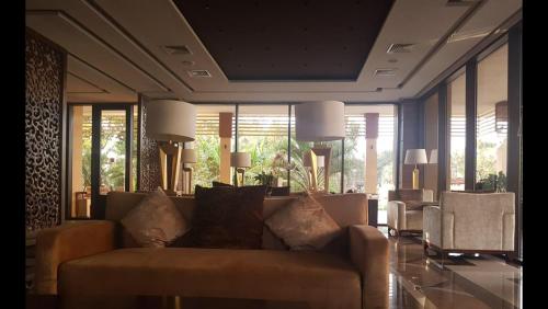 a living room with a couch and some windows at Dreamland oasis in Chakvi in Chakvi